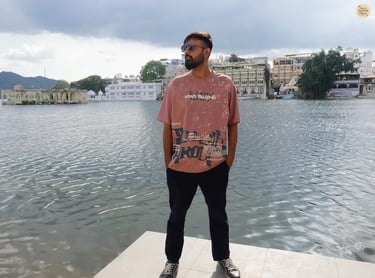 Serene lakeside scene with cloudy skies at Gangaur Ghat Udaipur Rajasthan India.