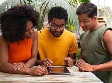 a group of people standing around a table
