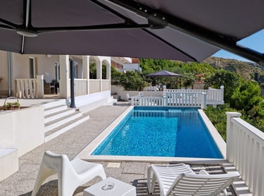 View from the west sun terrace of the pool, apartment balcony and the east sun terrace.