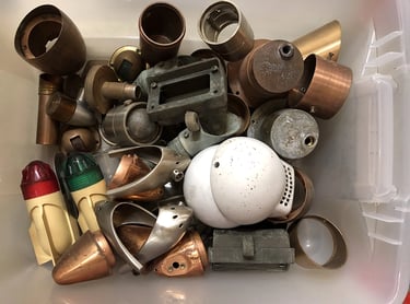 Various parts in a sculptor's workshop bin.