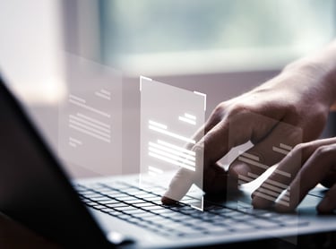 a person typing on a laptop computer screen