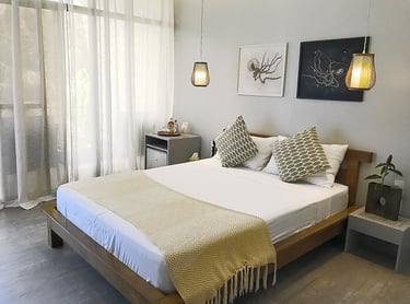 a bed with a white bed and a lamp