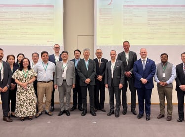 Members of S&TDC Kansai standing in front of a presentation