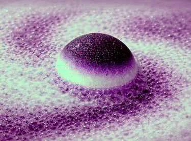 Extra large bath bomb with deep purple center surrounded by foamy lavender fizz.