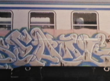 Graffiti on urban wall — layered street writing European calligraphy Kende