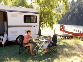 Camper by a lake with a canoe on a dock