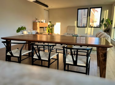 Handcrafted walnut dining table with sculpted legs and
