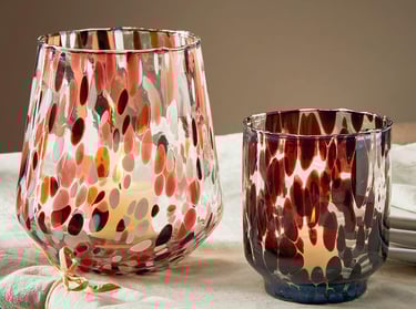 a candle holder in confetti glass