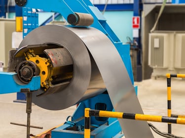 Steel coils passing through the decoiler