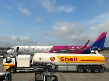 A plane being refueled by a Shell fuel truck