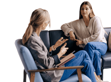 a woman sitting on a couch talking to a therapist