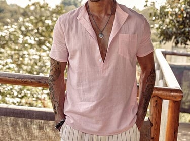 a man in a pink shirt and white shorts