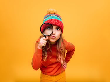 dziewczynka patrząca przez lupę