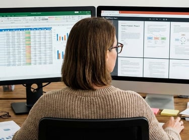 woman looking at computer screens