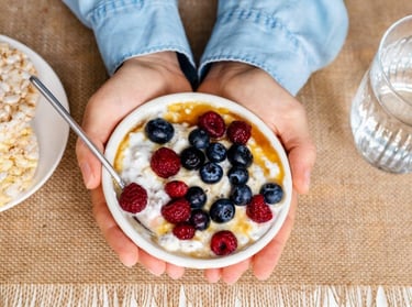 a person holding a bowl of cereal and cereal