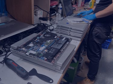 A TTB CircularIT employee refurbishes a batch of data-erased laptops
