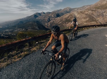 two men riding there bicycles in race- performance coaching
