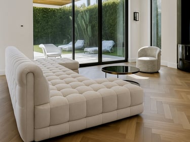 Modern living room with tufted beige sofa, round coffee table, and large glass doors to patio