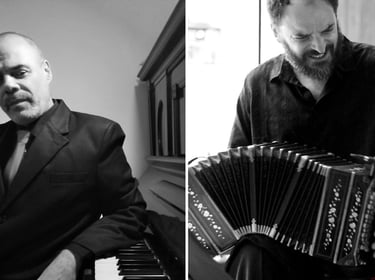a man in a suit and tie playing the accordion