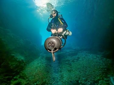 Solo diver, self relient, exploring a valley with a DPV