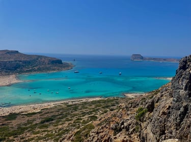 a view of a beach with boats and a blue sky
