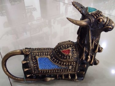  "Handcrafted brass bull sculpture with red and blue accents on the back – tribal-style-for overseas demand"