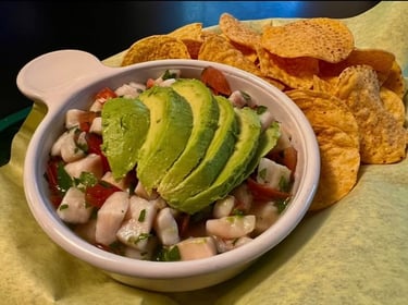 Ceviche served with lime, avocado and herbs