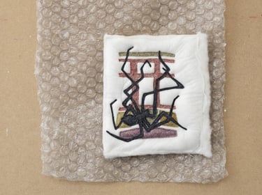 Applique textiles artwork of a spider.
