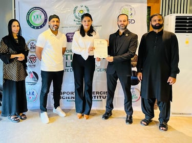 SESI Officials presenting a certificate of achievement to a female Personal trainer.