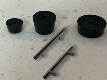 a table with a bunch of black plastic knobs