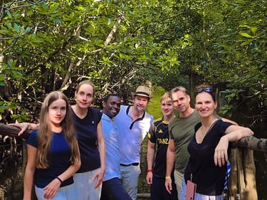 Group of tourists exploring Jozani Forest Zanzibar with a local tour guide during a wildlife and nature walk