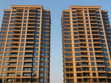Symmetrical architectural exterior of Chintels Paradiso, Gurugram, residential towers, golden hour sunlight, deep blue and warm gold tones, wide-angle, luxury architectural photography, 35mm