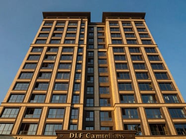 Wide-angle architectural exterior of DLF Camellias, Gurugram, modern high-rise, golden hour sunlight, deep blue and warm gold tones, symmetrical composition, luxury architectural photography, 35mm