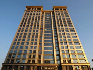 Wide-angle architectural exterior of DLF Arbour, Gurugram, high-rise luxury, golden hour sunlight, deep blue and warm gold tones, symmetrical composition, luxury architectural photography, 35mm