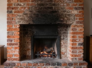 Restored firebox interior with clean bricks and mortar, ready for use, warm hearth light.