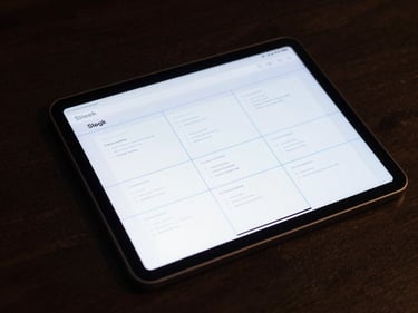 Sleek web design interface wireframe with clean layout grids and neon blue guides on a dark glass tablet, moody lighting.