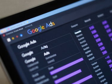 Macro close-up of a dark Google Ads dashboard interface with glowing purple metrics, sharp directional light blue rim lighting on a glass screen.