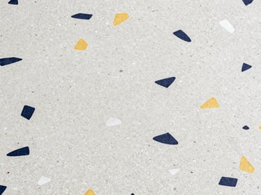 Detailed texture shot of polished terrazzo mosaic tile surface, showing fine aggregates, clean and reflective under studio lighting