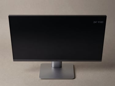 Overhead flat-lay of a 24-inch FHD monitor on a matte neutral surface, controlled studio lighting, bezel and port detail sharp, clean shadow, no lifestyle props