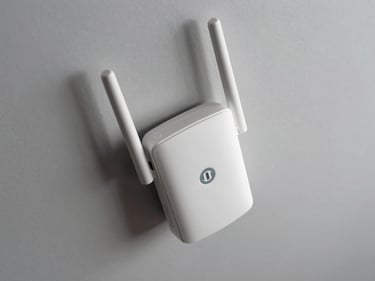 Overhead shot of a ceiling-mount Wi-Fi 6 access point on a neutral light grey surface, antenna array and ethernet port visible, studio strobe overhead lighting, no text or lifestyle staging