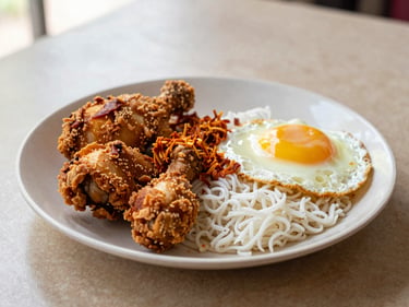 A plate of Nasi Lemak with fried chicken, sambal, and egg, on a textured table with warm natural light, appetizing close-up
