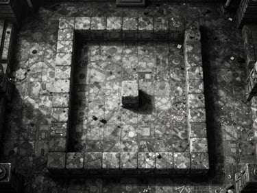 Frontal in-engine screenshot of a top-down dungeon crawler, sharp monochrome tile grid, harsh directional light casting hard shadows on stone floor, no render art
