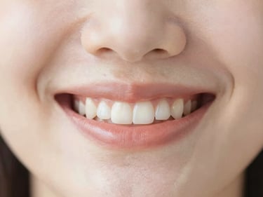 Macro shot of a healthy, natural smile, soft lighting, warm tones, clean clinical aesthetic