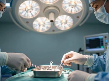Close detail of a surgeon's gloved hands positioning a sterile instrument tray under bright operating theater lights, stainless steel tools aligned in precise order