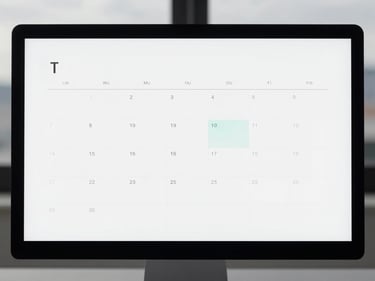 Minimalist calendar interface on a monitor, highlighting scheduled meetings, diffused daylight.