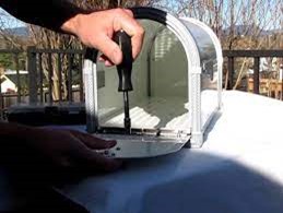person fixing mailbox door