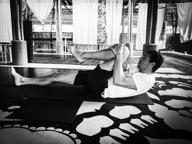 A man practising yoga on a mat