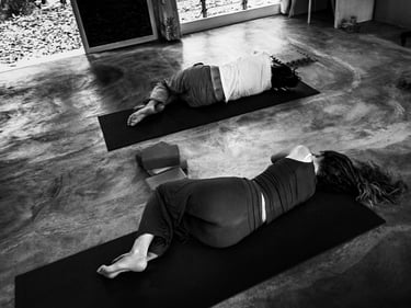 Yoga students lie on their right side as part of a relaxation practice