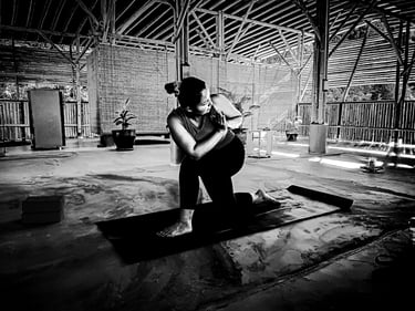 A woman practising a variant of Equestrian Pose a during yoga class