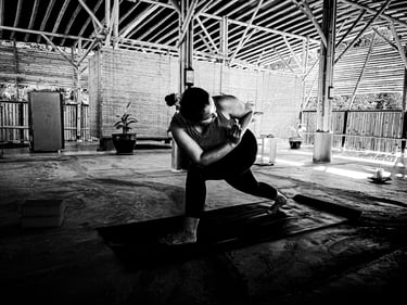 A woman practices a twisting yoga pose